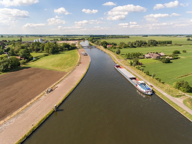 Free photo aerial shot of the merwede canal near the arkel village located in the netherlands