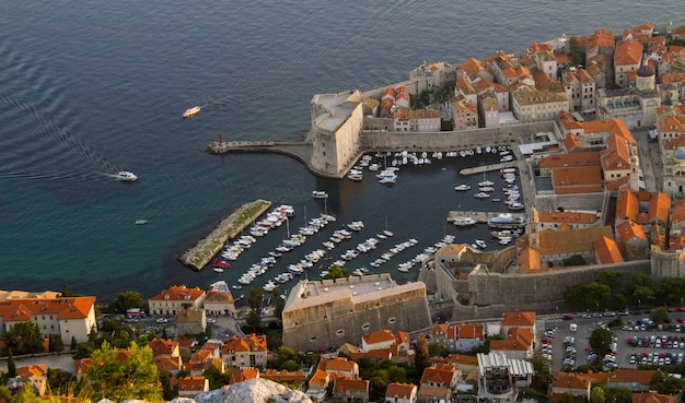 Aerial shot of the mountain Srđ in Dalmatia, Croatia with its cute orange houses and busy streets