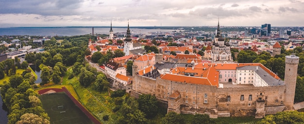 Aerial shot of the old town of Tallinn with orange roofs, churches' spires and narrow streets