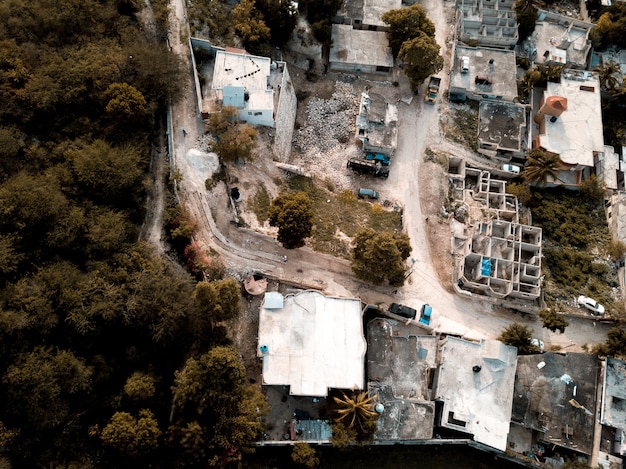 Aerial shot of roads in the middle of old buildings near trees