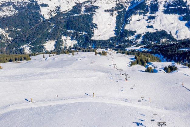 Free Photo aerial shot of a ski resort on a snowy mountain during daylight