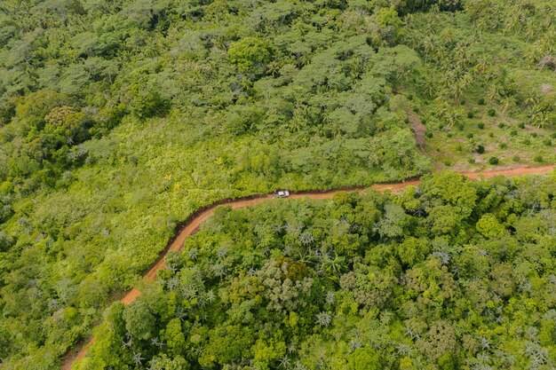 Aerial Shot View of Truck Driving Up to the Winding Curve Road of Mountain Top