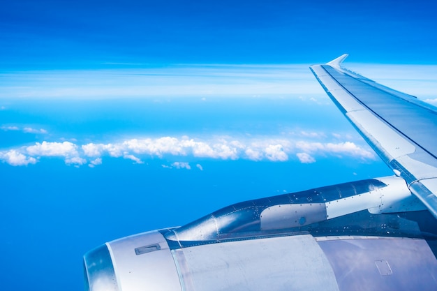 Free Photo aerial view of airplane wing with blue sky