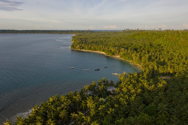 Aerial view of the beach with white sand and turquoise clear water in Indonesia