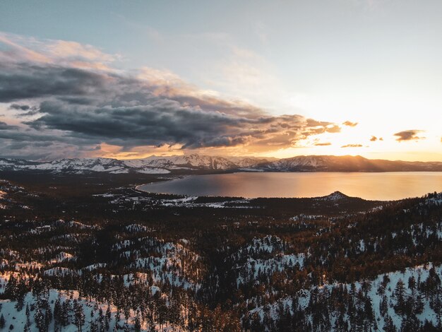 Aerial view of the beautiful Lake Tahoe captured on a snowy sunset in California, USA