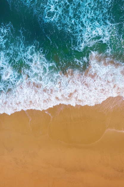 Free Photo aerial view of blue ocean wave on sand beach.