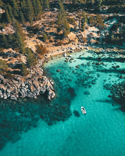 Aerial view of a boat on the water at the rocky beach