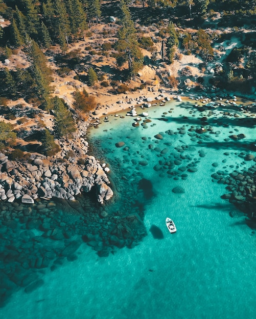 Aerial view of a boat on the water at the rocky beach