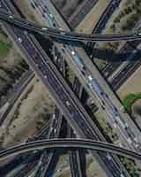 Free photo aerial view of a busy highway intersection full of traffic during daytime