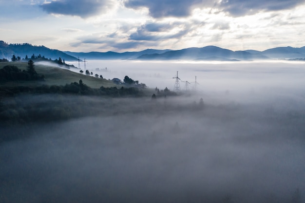 Free photo aerial view of colorful mixed forest shrouded in morning fog on a beautiful autumn day