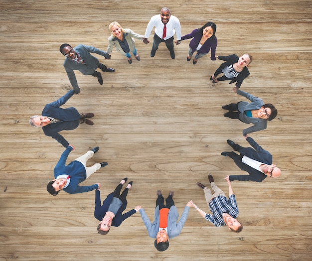 Free photo aerial view of diverse business people holding hands togeher teamwork