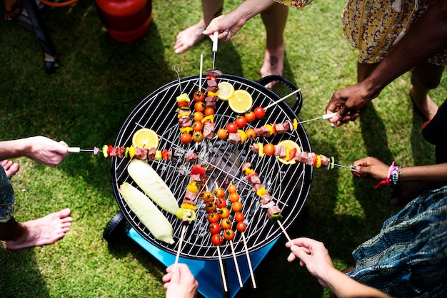 Free photo aerial view of a diverse group of friends  grilling barbecue outdoors