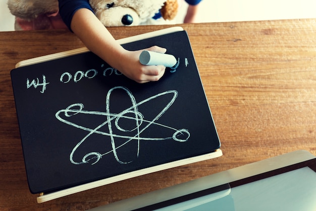 Free Photo aerial view of kid hand drawing on chalkboard