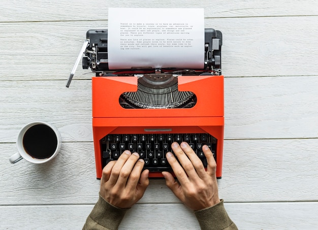 Free photo aerial view of a man typing on a retro typewriter