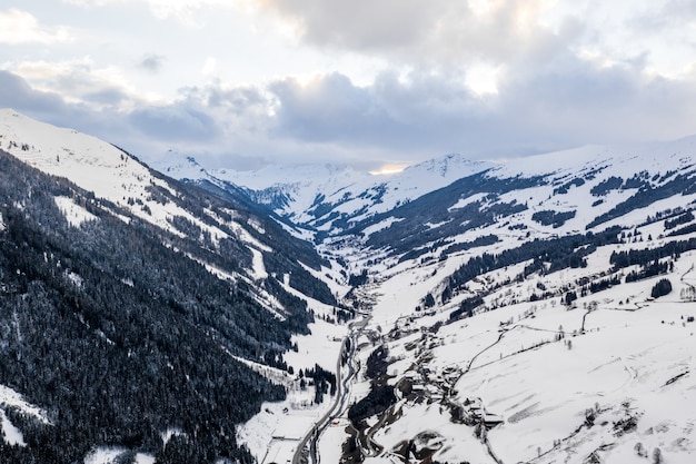 Free photo aerial view of mountain peaks covered with snow at daytime