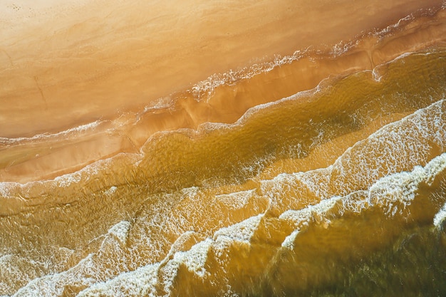 Aerial view of the ocean wave reaching the coastline