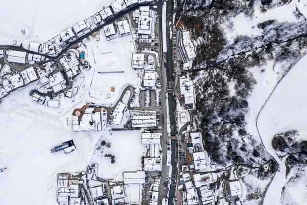 Aerial view of a resort town in Austria surrounded by snowy mountains