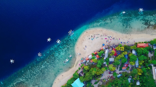 Free photo aerial view of sandy beach with tourists swimming in beautiful clear sea water of the sumilon island beach landing near oslob, cebu, philippines. - boost up color processing.