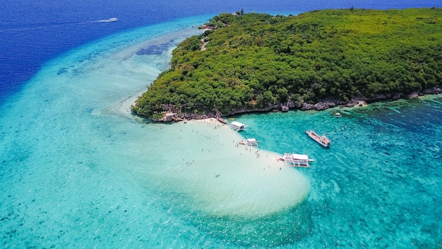 Free photo aerial view of sandy beach with tourists swimming in beautiful clear sea water of the sumilon island beach landing near oslob, cebu, philippines. - boost up color processing.