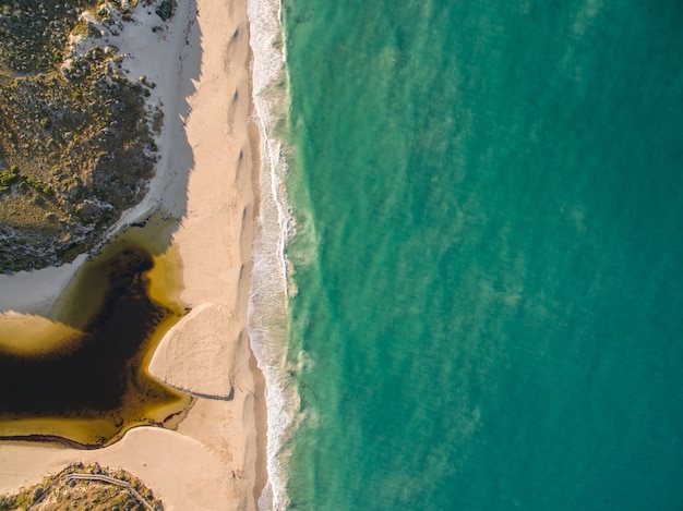 Aerial view of the shore surrounded by the sea under the sunlight at daytime - cool for wallpapers