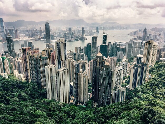 Aerial view of the Victoria Peak hill in Hong Kong under the cloudy sky