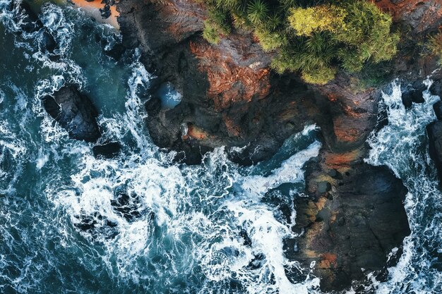 Aerial view of the waves of the sea crashing on the cliffs