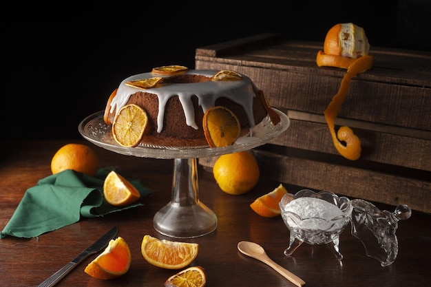 Free photo aesthetic vibrant shot of an orange cake covered by sweet sugar icing