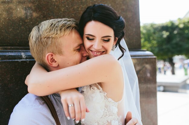 Affectionate bride hugging her husband