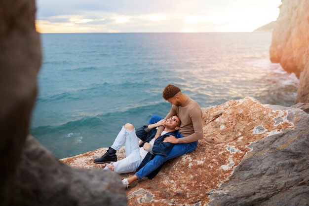 Free photo affectionate gay couple spending time on the beach together