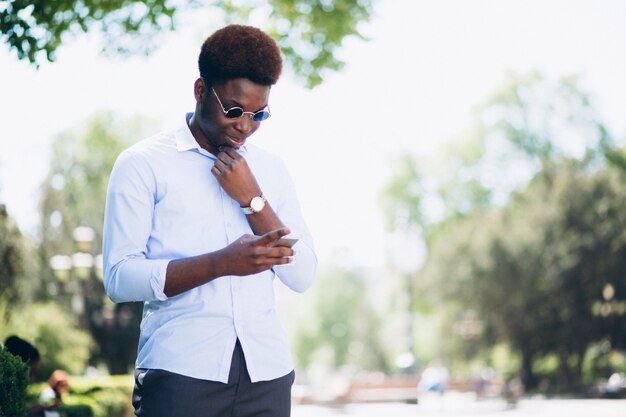 African american business man with phone in the street