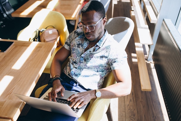 African american business man working with laptop in a cafe