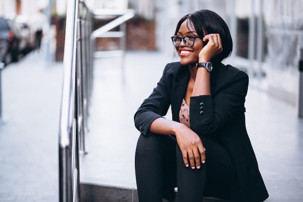 African american business woman sitting on the stairs