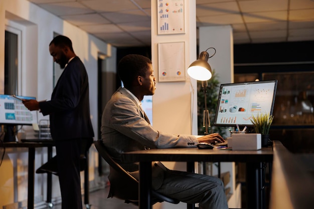 Free photo african american businessman looking at financial graphs