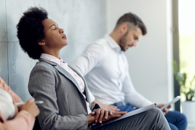 African American businesswoman trying to concentrate while waiting for a job interview