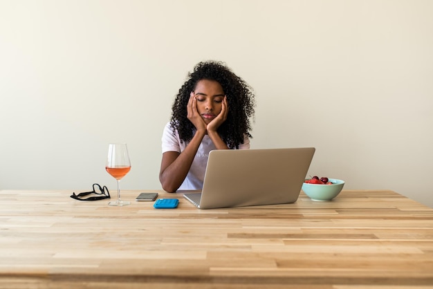 African American female freelancer using laptop at home