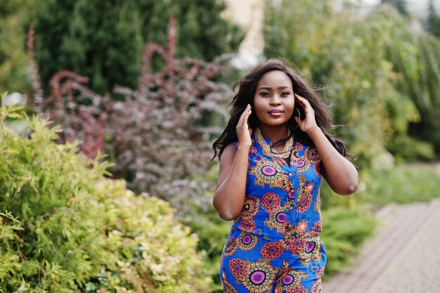 African american girl in coloured clothes posed outdoor Fashionable black woman