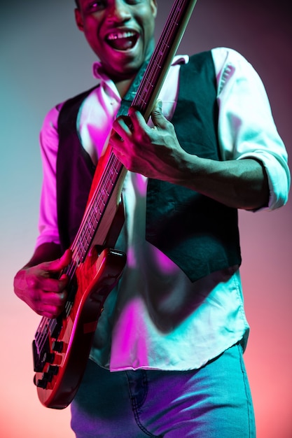 African American jazz musician playing bass guitar.