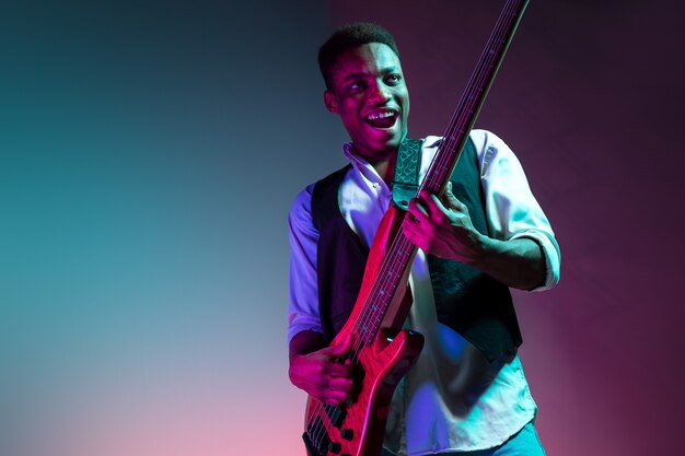 African American jazz musician playing bass guitar