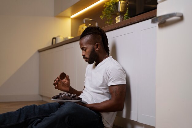 African american man eating on the floor