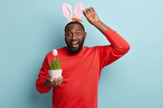 African American man holding plant