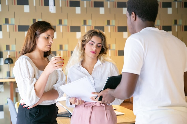 Free Photo african american man showing tablet screen to partners