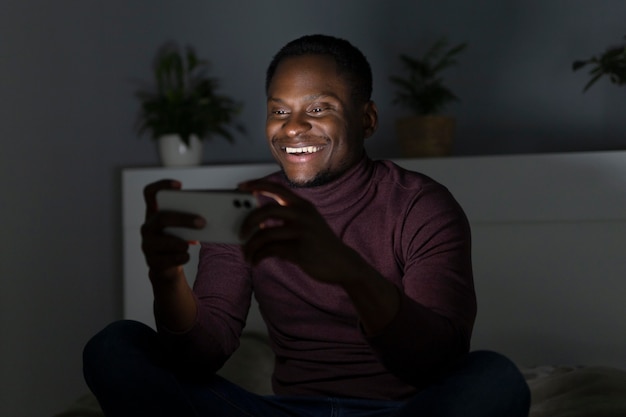 African american man watching streaming service indoors