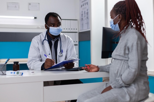 African american medic and pregnant woman talking