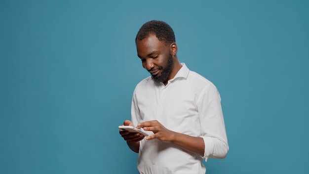 African american person working on modern smartphone to search job information on website. Executive manager browsing internet on mobile phone with social media app and technology.