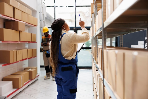 African american storehouse manager checking parcels maintenance