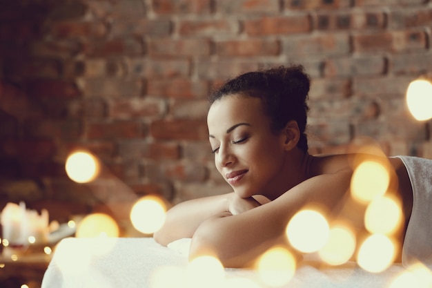 African American woman receiving a relaxing massage at the spa