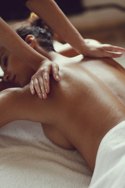 African American woman receiving a relaxing massage at the spa