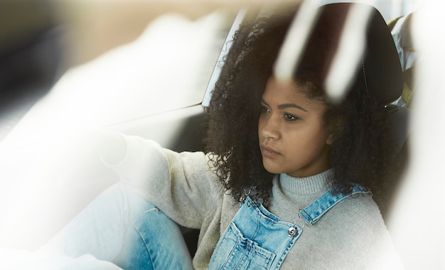 african american woman sitting posing inside her car