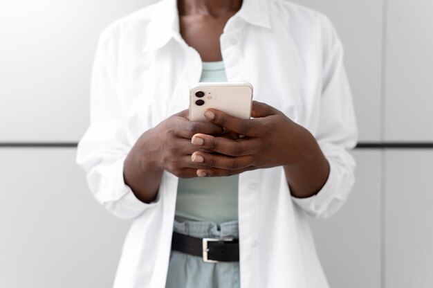 African american woman texting someone on her smartphone