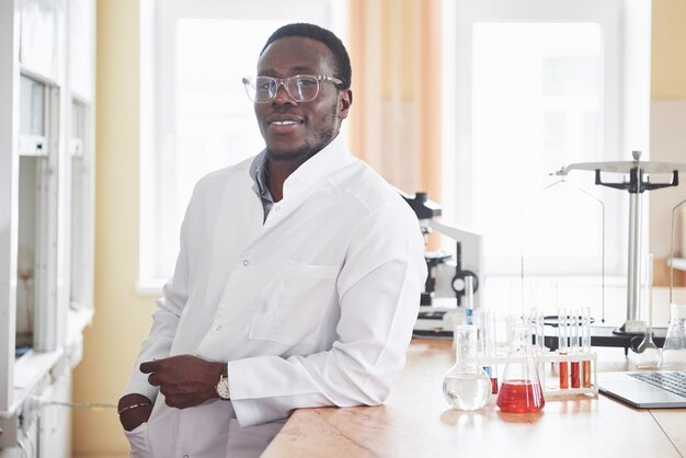 An African American worker works in a laboratory conducting experiments.